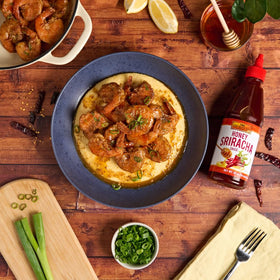 Sticky wings glazed with honey sriracha for bold flair.