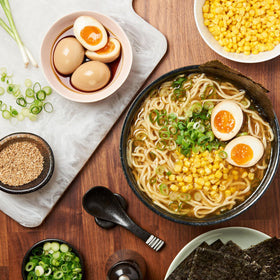 Lee Kum Kee Less Sodium Soy Sauce poured over noodles for balanced seasoning