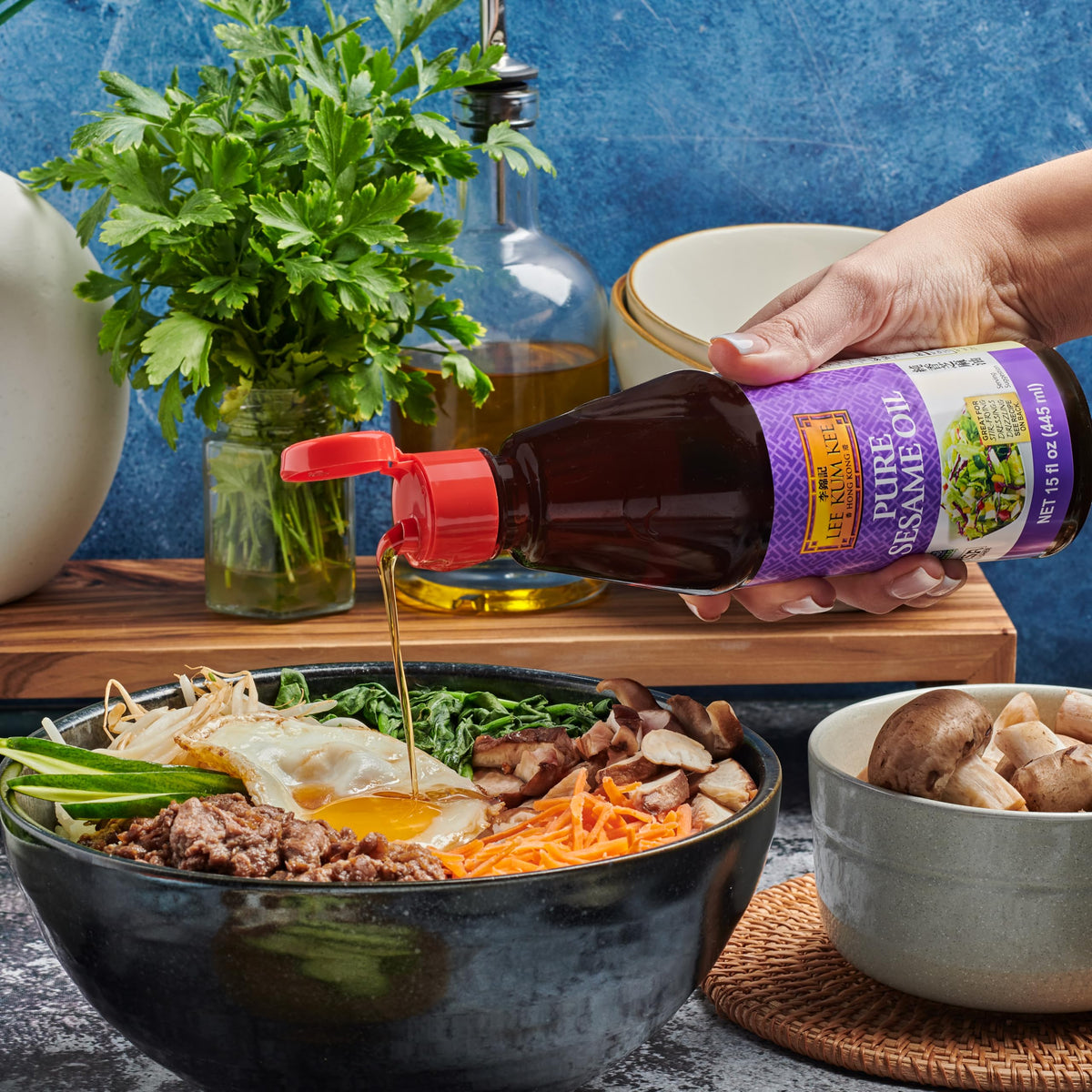 Lee Kum Kee Pure Sesame Oil kitchen scene emphasizing versatility