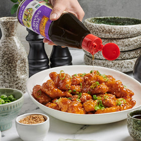 Lee Kum Kee Pure Sesame Oil stir-frying vegetables in wok