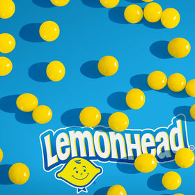 LEMONHEAD candies close-up showing round lemon shapes and glossy coating