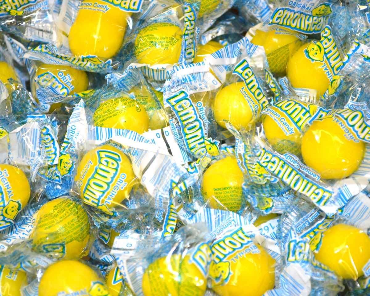 Lemonheads bulk 5lb yellow bag; tangy candies ideal for party favors.