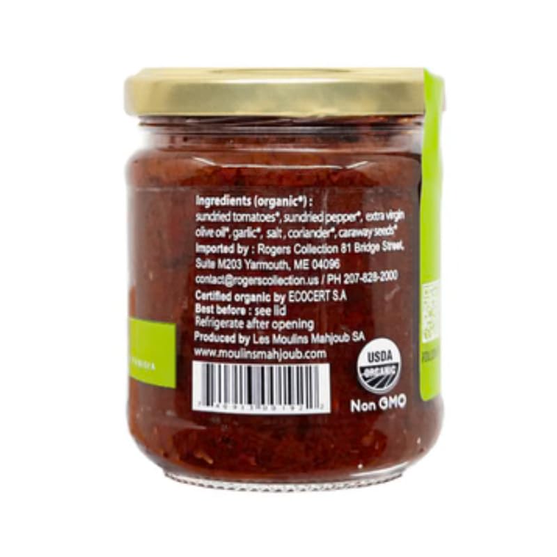 Les Moulins Mahjoub Harissa Spread on plate with bread and olives, perfect dip or appetizer.