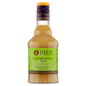 Liber & Co. Toasted Coconut Syrup bottle on bar setup for tropical cocktails