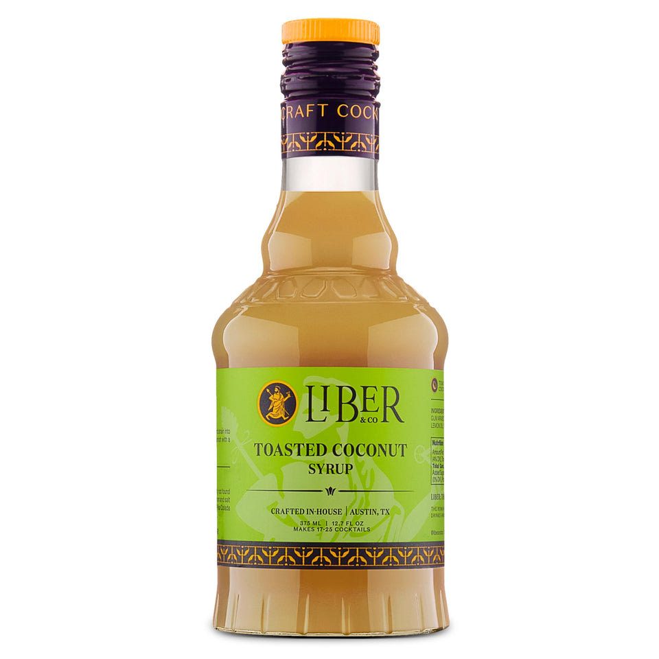 Liber & Co. Toasted Coconut Syrup bottle on bar setup for tropical cocktails