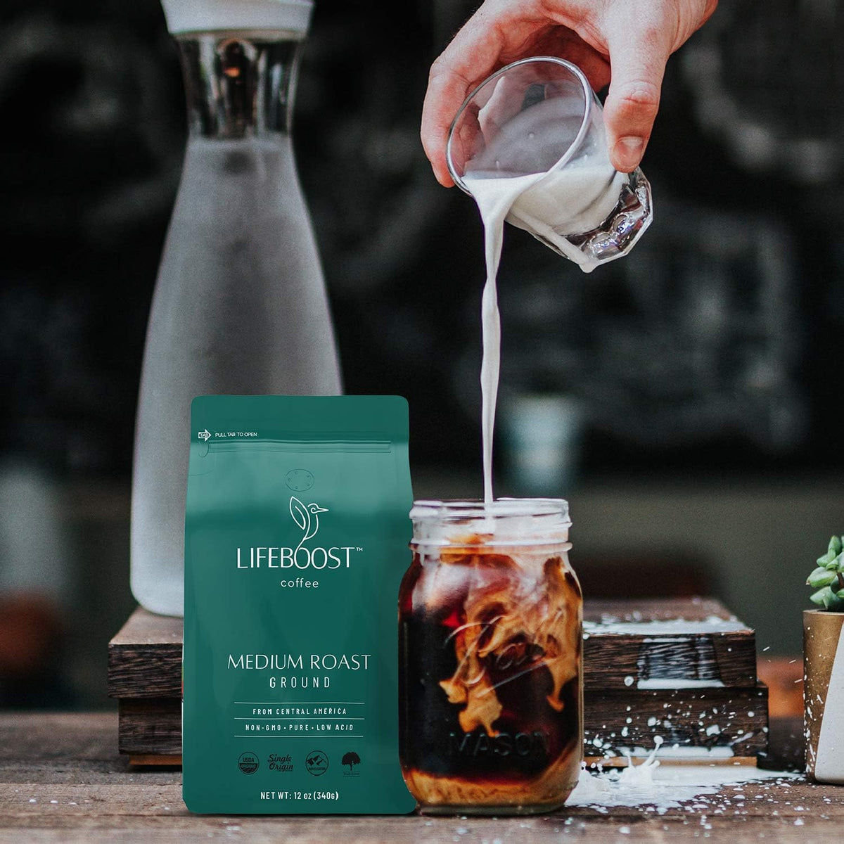 Lifeboost Coffee Ground Medium Roast ground coffee flowing into a filter for brewing.