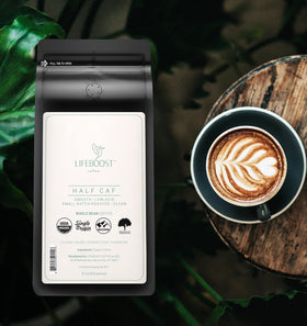 Lifeboost Half Caff coffee beans close-up highlighting hand-sorted, shade-grown quality.