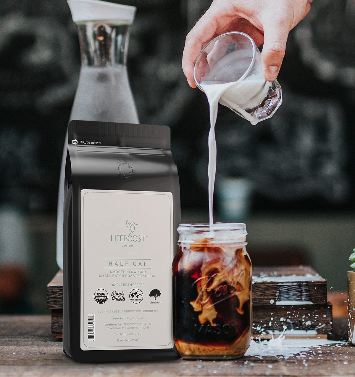 Lifeboost Half Caff cup with steam emphasizing rich aroma and low acidity profile.