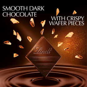Lindt EXCELLENCE Crispy Wafer pieces closeup highlights crisp wafer crunch with rich chocolate.