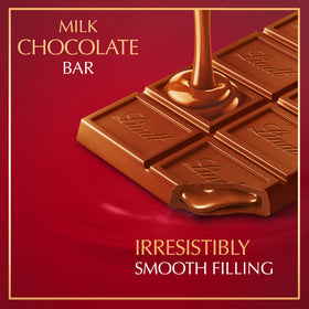 Close-up of Lindt LINDOR Milk Bar smooth center, promising a creamy melt.