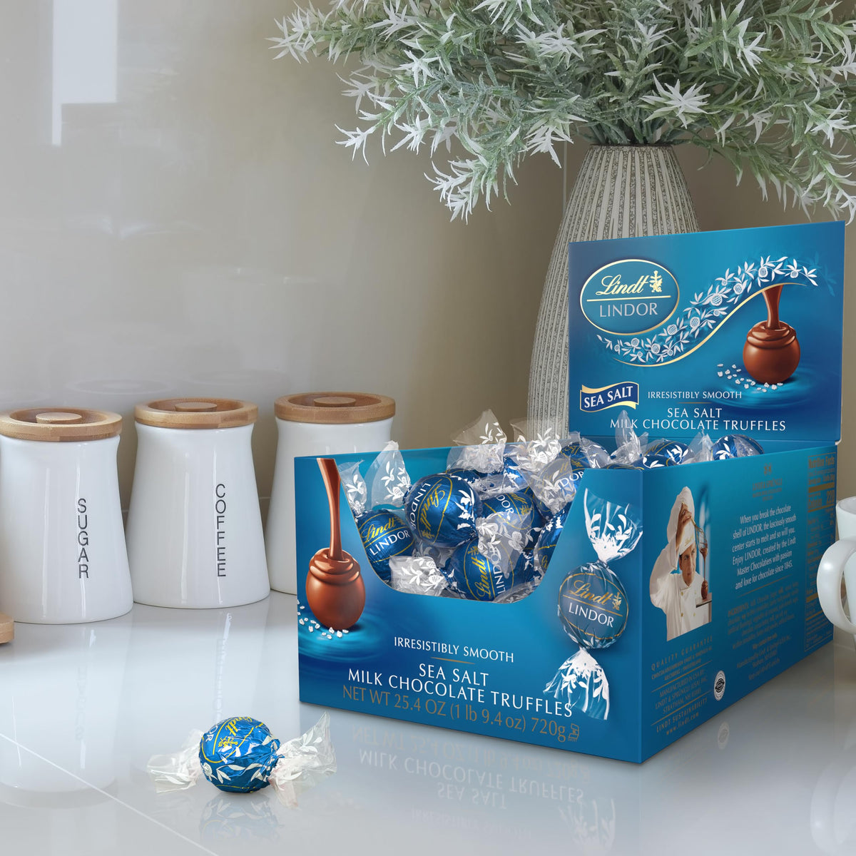 Lindt LINDOR sea salt milk chocolate shell close-up highlighting smooth melt.