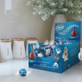 Lindt LINDOR sea salt milk chocolate shell close-up highlighting smooth melt.