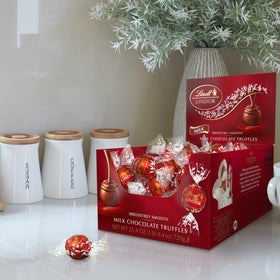 Lindt LINDOR truffle center melting, inviting smooth texture.