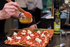 Liokareas Organic EVOO bottle pouring, perfect for drizzling over salads