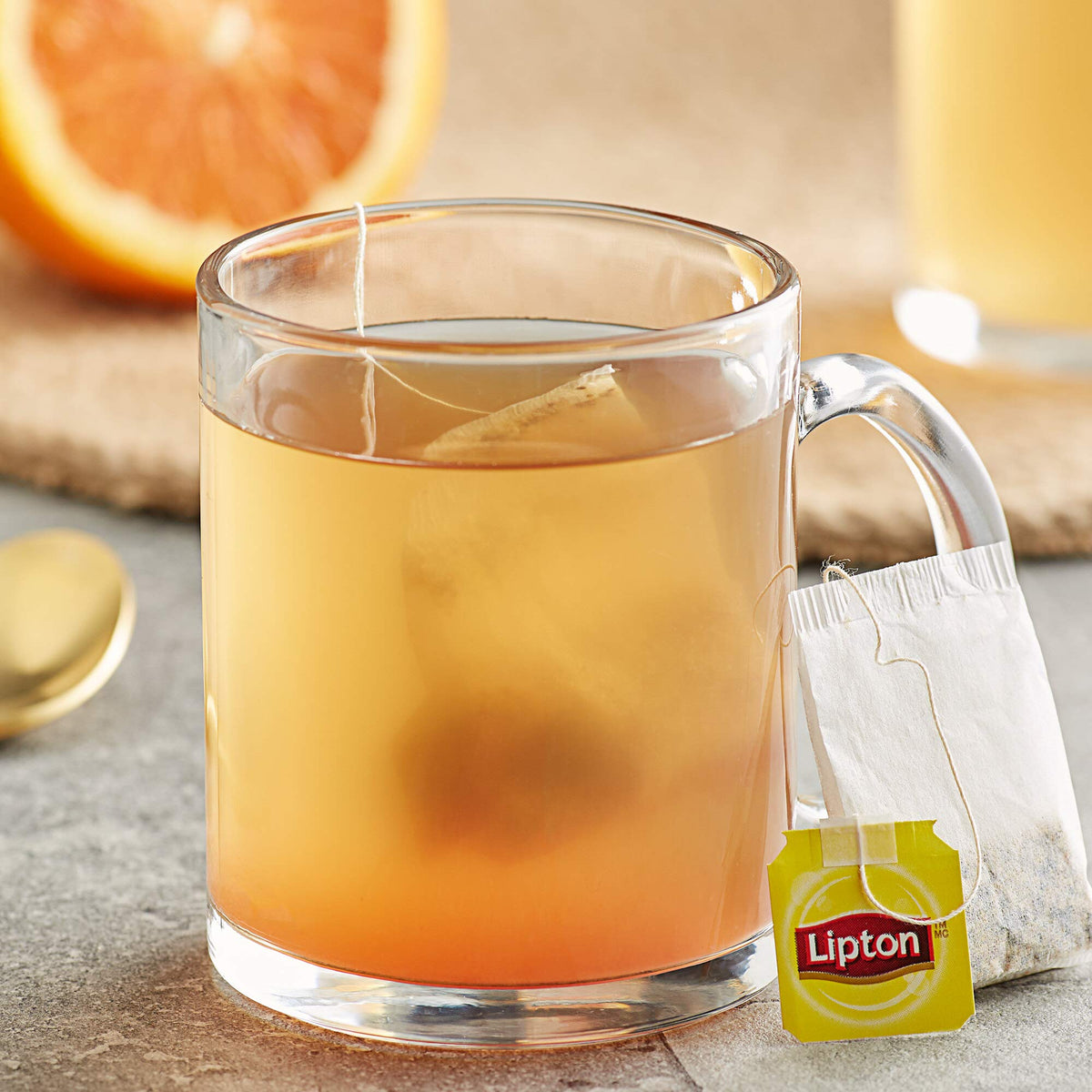 Lipton orange herbal tea cup on saucer ready to enjoy.