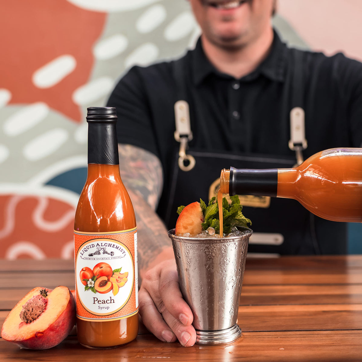 Liquid Alchemist Peach Syrup close-up shows vibrant color.