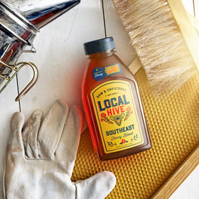 Closeup of Local Hive Southeast Honey label showing branding and color.
