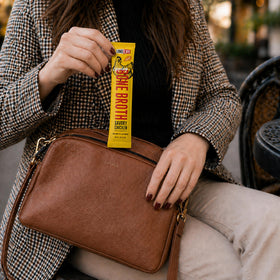 LonoLife on-the-go bone broth stick in a travel mug