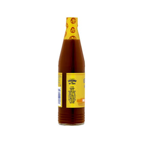 Louisiana Sweet Heat Honey Hot Sauce glass bottle on kitchen counter ready to spice.