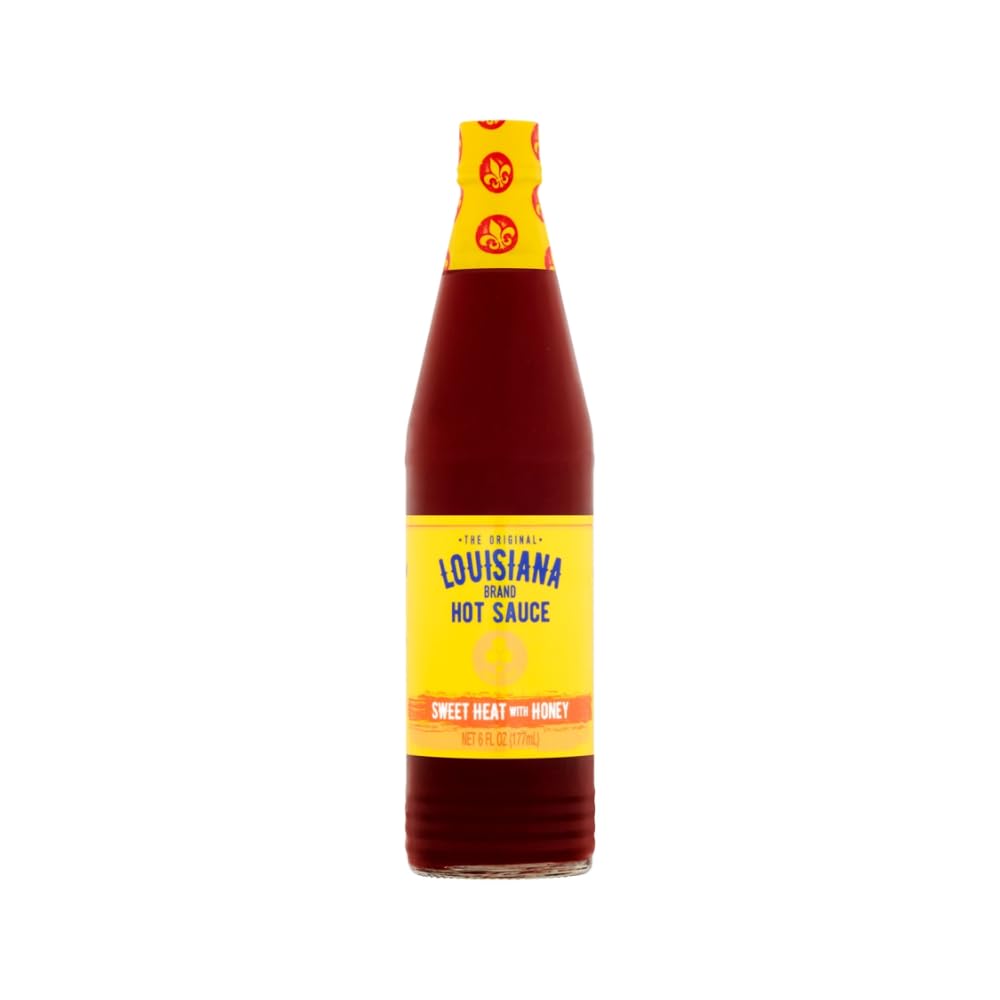Louisiana Sweet Heat Honey Hot Sauce bottle being poured to glaze wings.