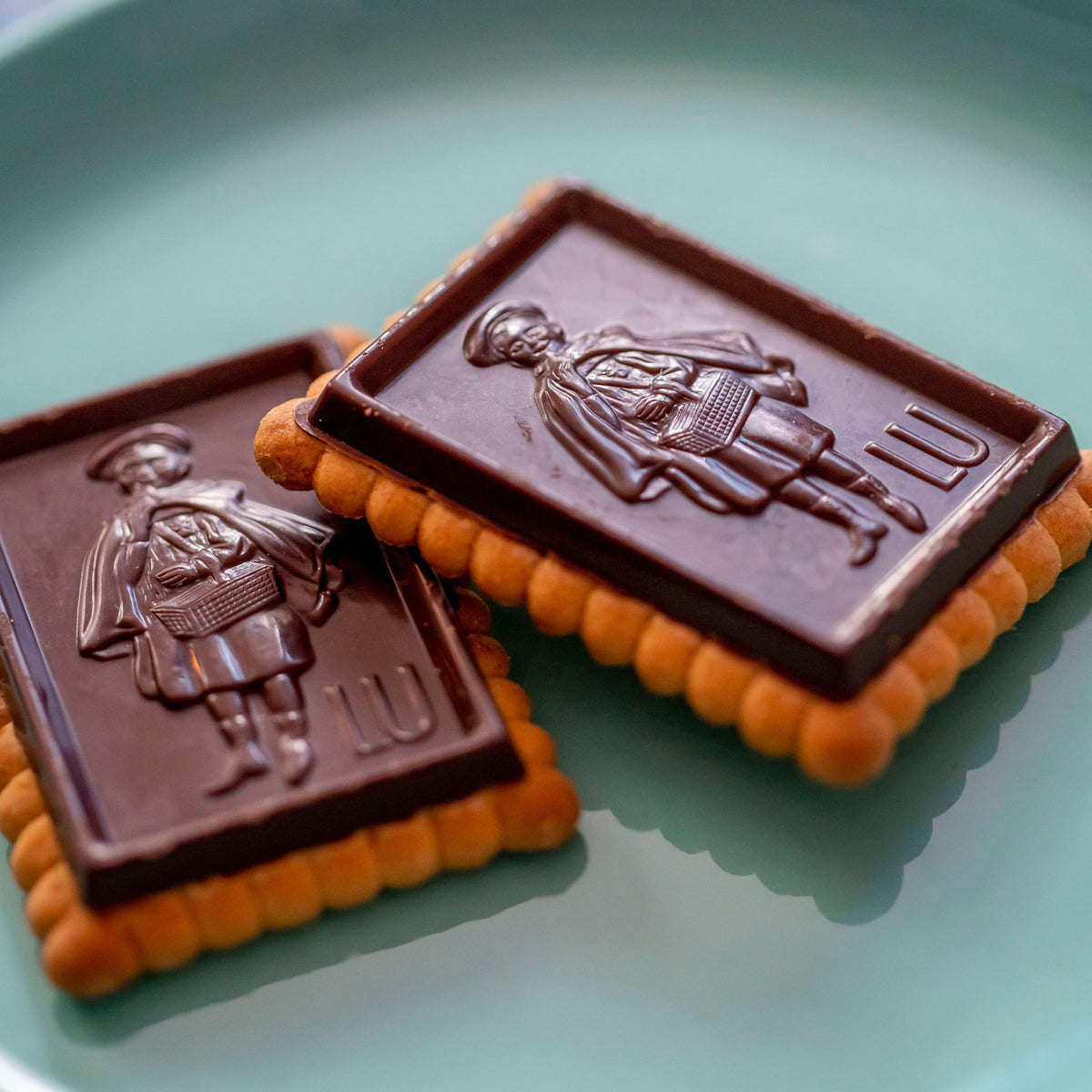 Elegant cookie stack on a platter with LU branding, ideal for parties.