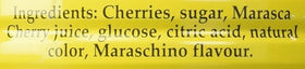 Luxardo cherries on a cocktail glass with garnish.