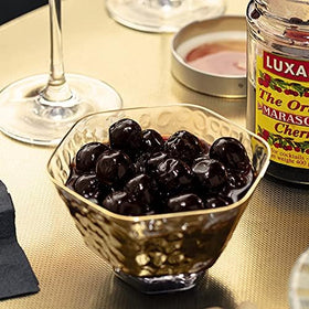 Luxardo Maraschino Cherries closeup syrup, rich soaking liquid and ruby fruit.