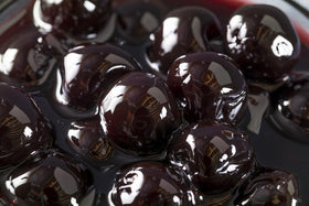 Luxardo cherries on a dessert plate elevate tarts and cakes with vibrant color.