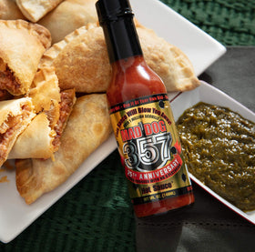 Mad Dog 357 Gold Edition sauce splash showcasing bold color and texture.