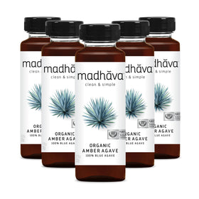 Madhava Amber Agave bottle with six-pack for clean, natural sweetness in beverages.