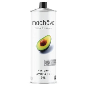 MADHAVA Avocado Oil 1L tin pouring into a pan for high-heat cooking.