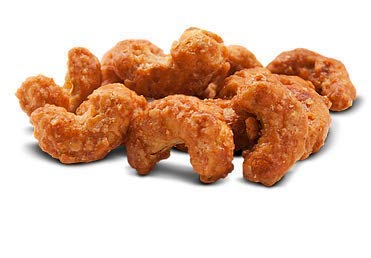 Close-up of Magic Bavarian Cinnamon Roasted Cashews coating, showcasing glossy cinnamon sugar.