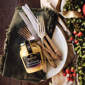 Maille Dijon Originale jar serving with creamy texture for sauces.