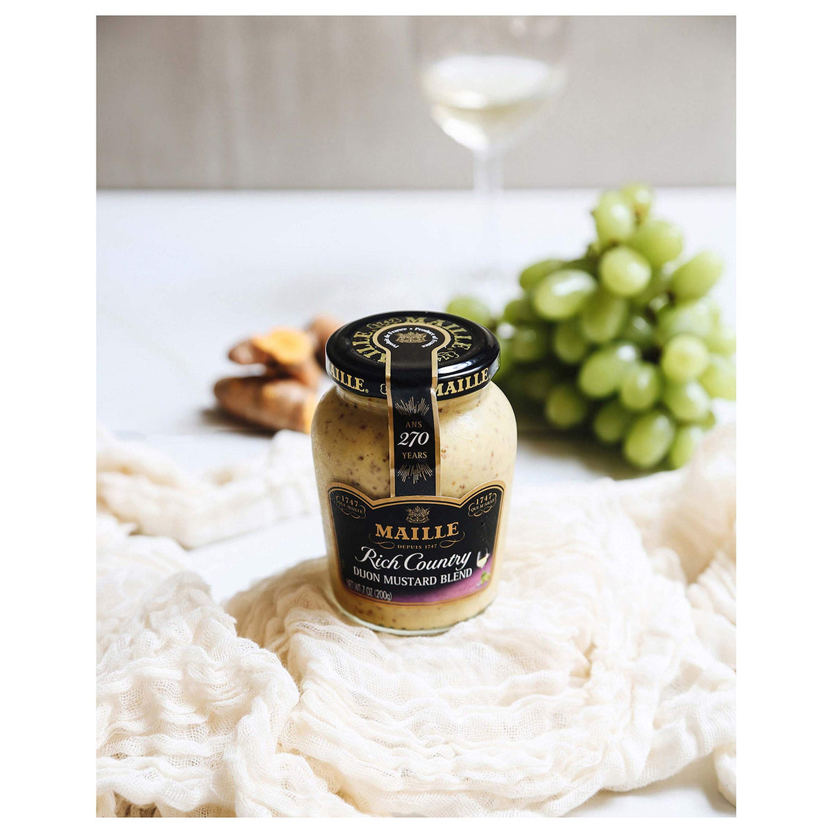 Bowl of Maille Rich Country Dijon dressing for salads.
