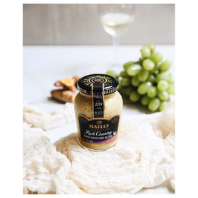 Bowl of Maille Rich Country Dijon dressing for salads.