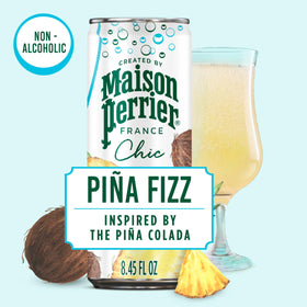 Maison Perrier Chic Piña Fizz in a chilled glass with pineapple slices for a mocktail.