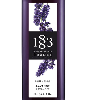 Close-up of 1883 lavender syrup bottle pouring for floral cocktails.