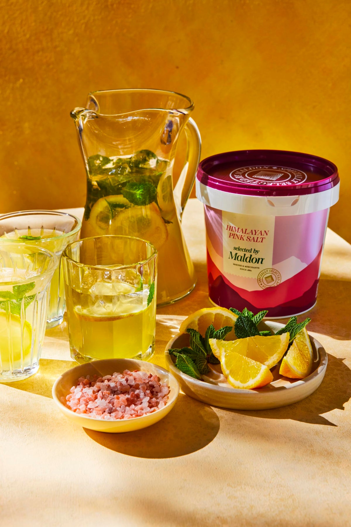 Maldon Himalayan pink salt in a glossy bowl showing flaky texture.