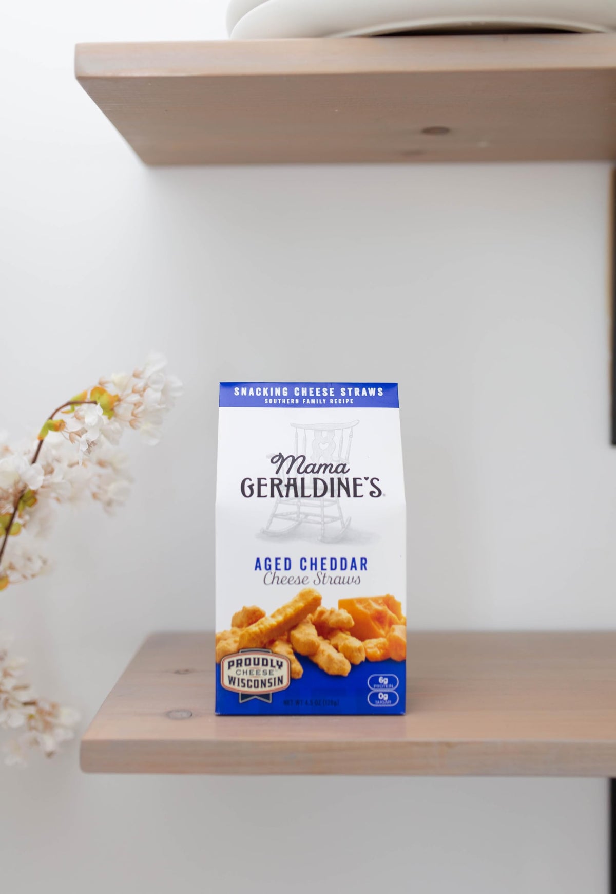 Mama Geraldine's cheddar cheese straws on a charcuterie board for sharing and entertaining.