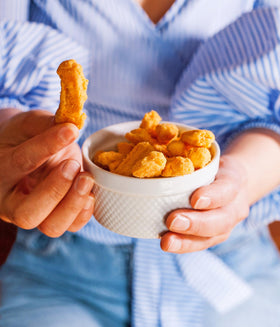 Mama Geraldine's cheddar cheese straws in a lunchbox, ideal for kids and adults alike.