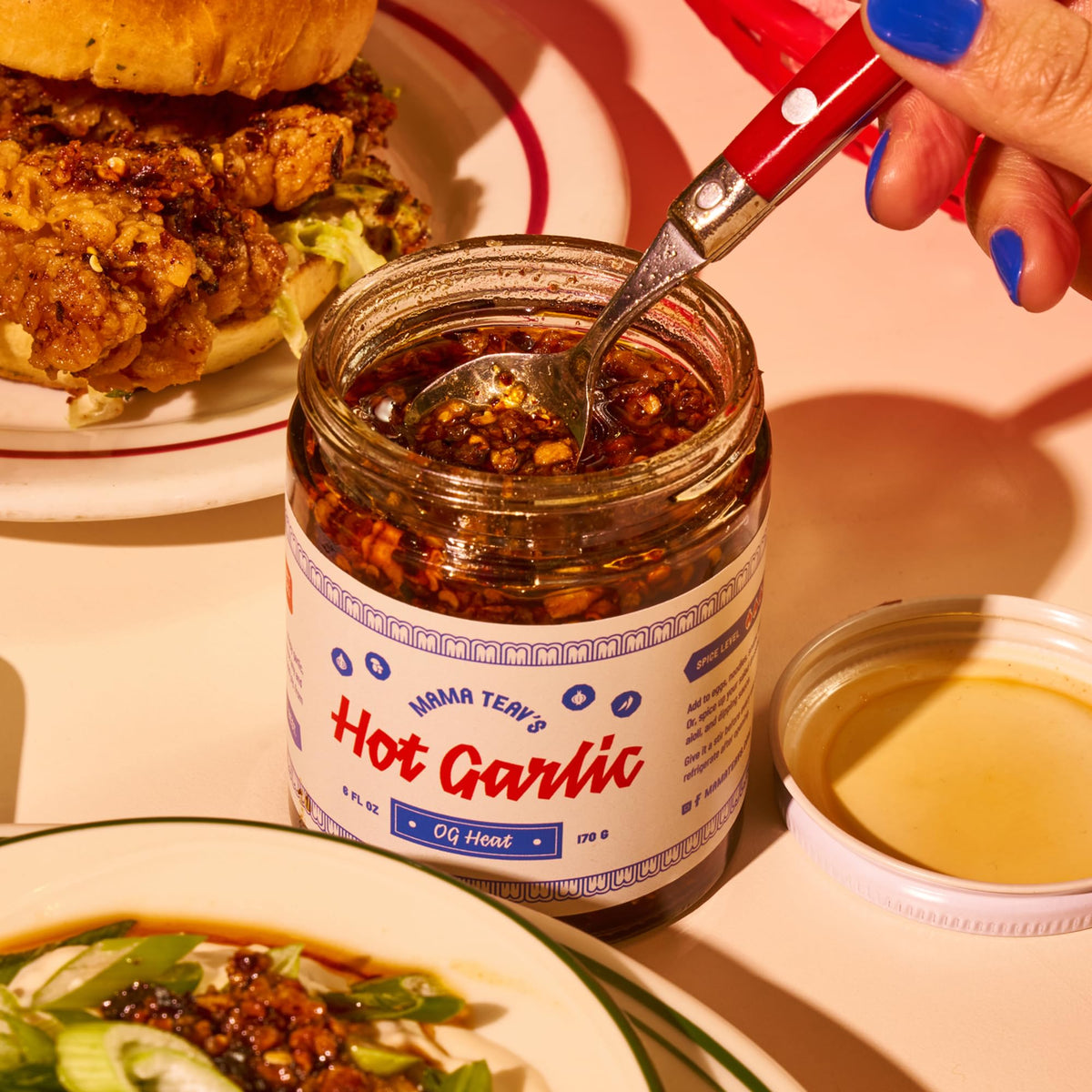 Pouring Mama Teav's Chili Crisp to boost flavor and aroma.