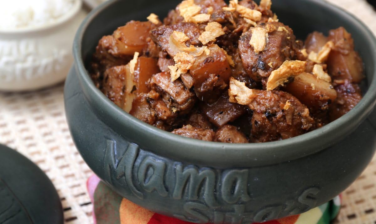 Mama Sita's Adobo sauce mix serving as a flavorful glaze in a bowl.