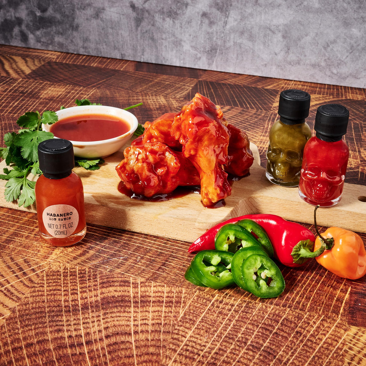Man Crates Hot Sauce Inferno Flight skull bottles stand out on shelves.