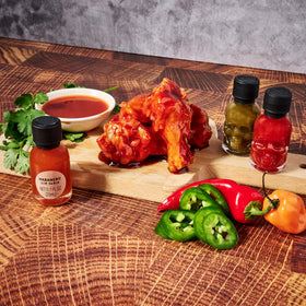 Man Crates Hot Sauce Inferno Flight skull bottles stand out on shelves.