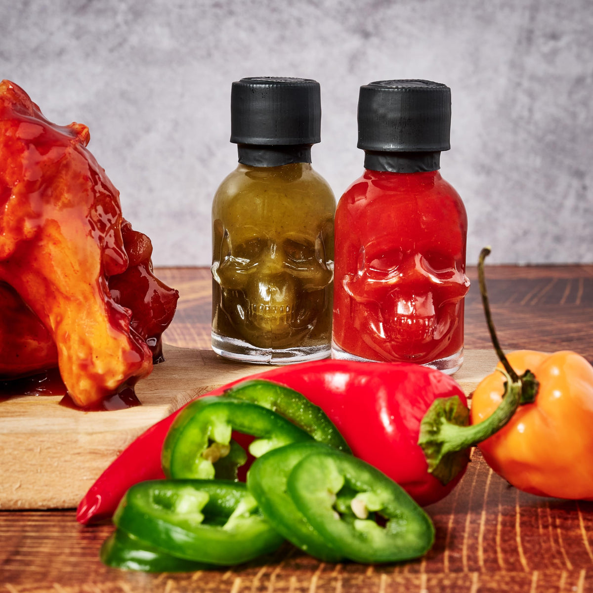 Man Crates Hot Sauce Inferno Flight glass skull bottles highlight a bold, collectible display.