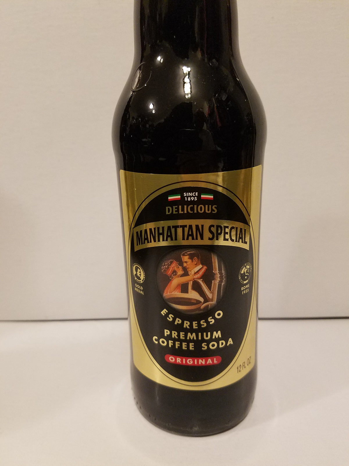 Manhattan Special Expresso Coffee Soda bottle angled for serving, ideal for a retro experience.