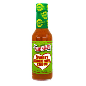 Pouring Marie Sharp's Sweet Habanero onto fries for a sweet heat glaze