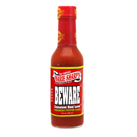 Pour shot of Marie Sharp's Beware Comatose hot sauce to show fiery consistency