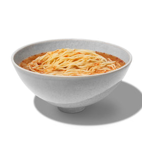 Close-up of Maruchan Gold noodles and spices showing rich flavor.