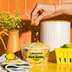 Maruchan instant rice bowl chicken serving close-up shows steaming, speedy lunch.